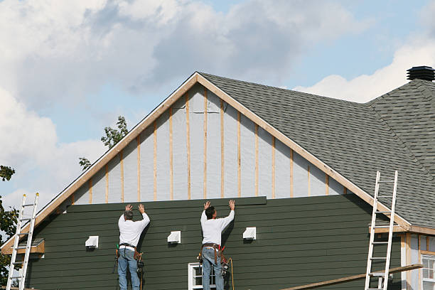 Professional Storm Damage Siding Repair technician working in Barberton, OH
